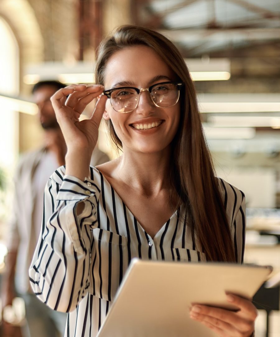 successful business woman young cheerful woman holding digital tablet and looking at camera with e1656537708314